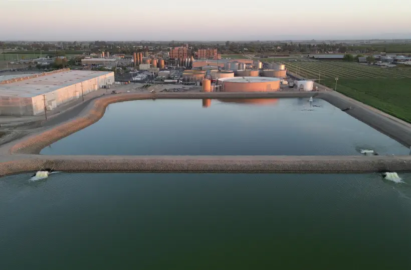 aerial view of a pond near a building