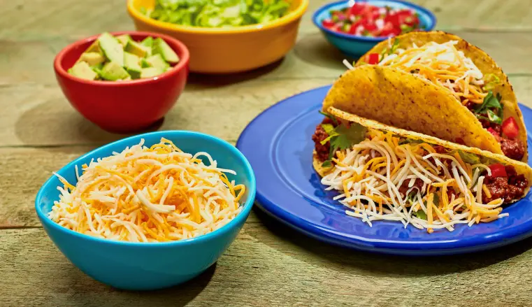 taco plate with cheese and condiment sides