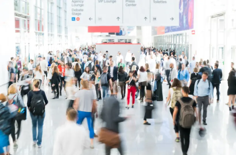 Crowded terminal with people walking around.