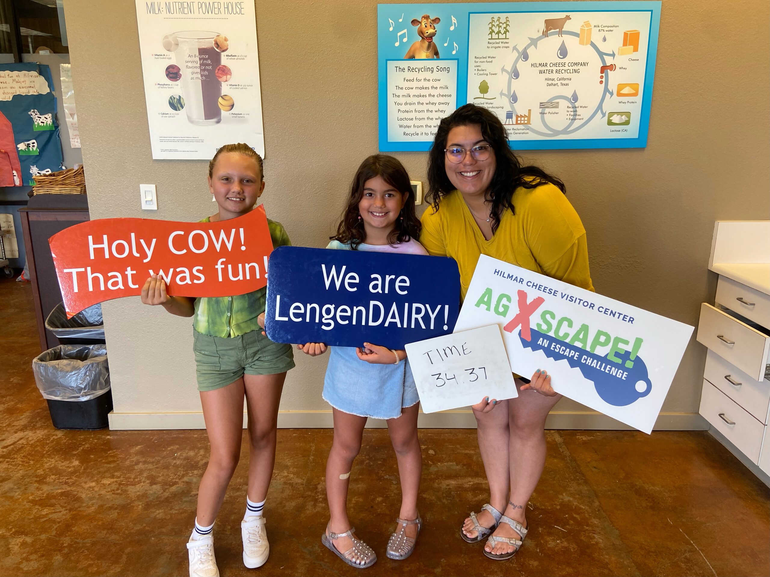 three people with signs after fun escape game