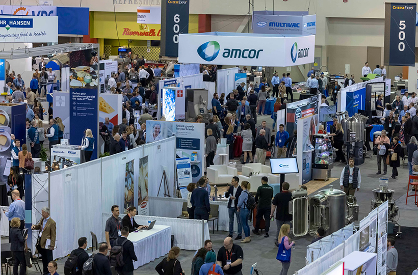 Attendees explore the exhibit hall at CheeseExpo