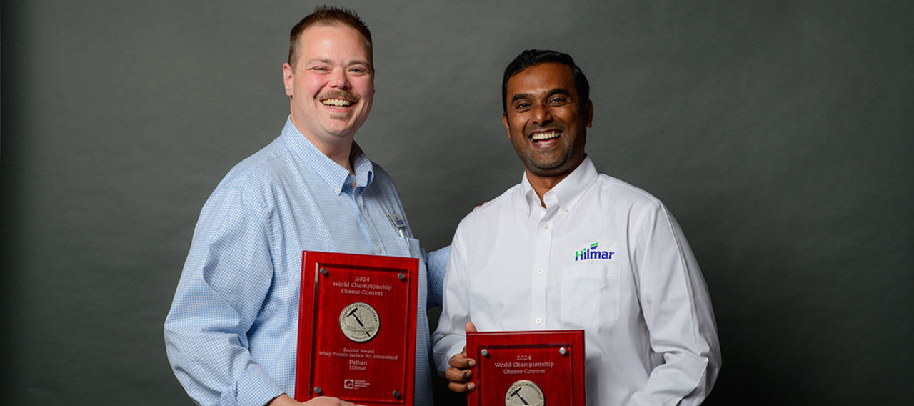 Hillmar's Ben Smith and Muthu Ramanathan pictured with two silver medals at the 2024 World Championship Cheese Contest awards banquet