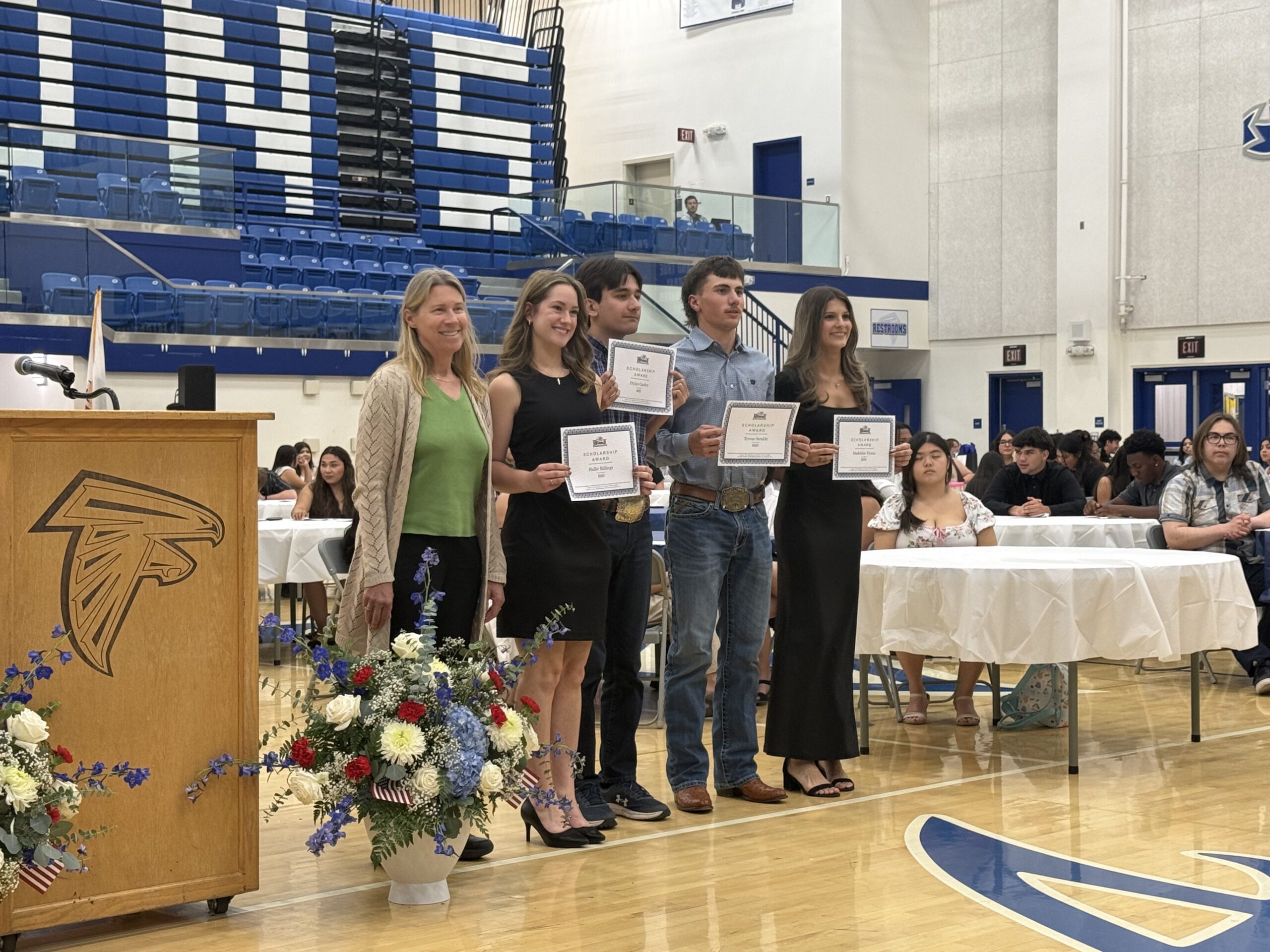 group photo of 4 students receiving scholarship certificates